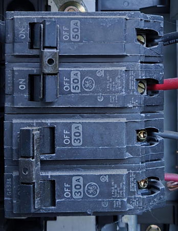 Close-up of residential circuit breaker switches inside an electrical panel